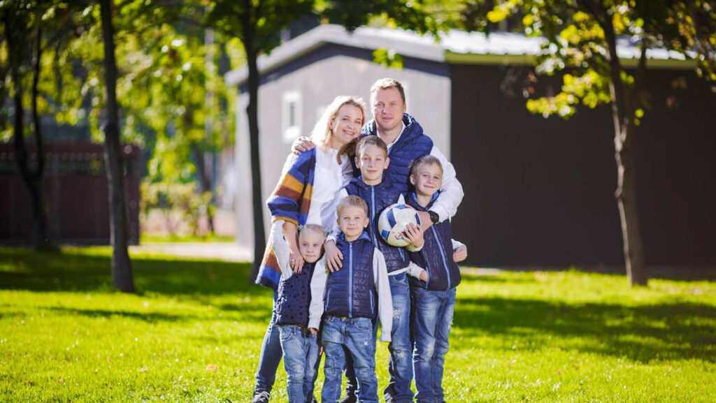 solar-panel-prices-south-africa-happy-family-outdoors-happy-caucasian-family-standing-outside-their-house-and-hugging-family-with-four-children-in-front-house